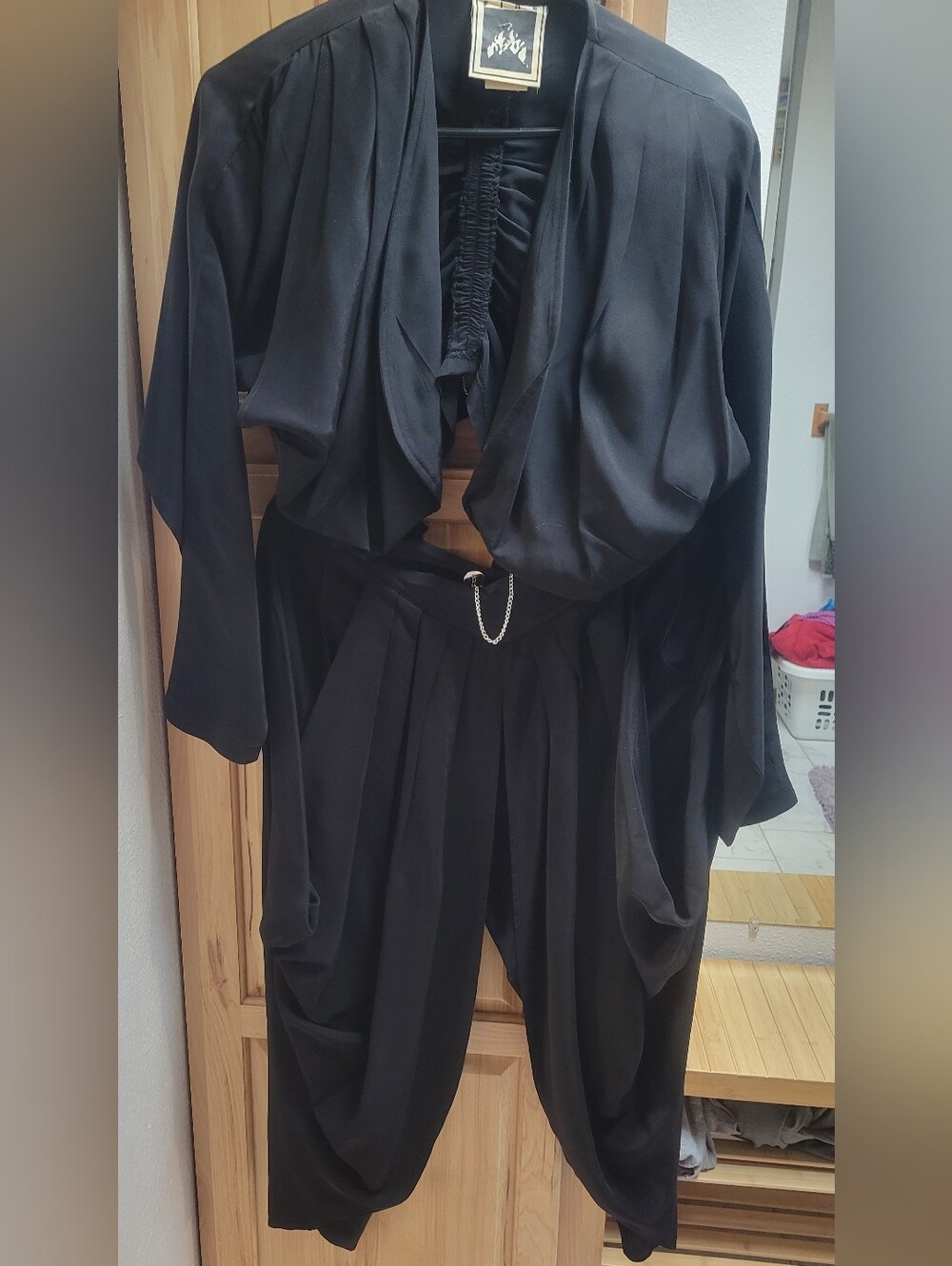 Elegant Black Draped Jumpsuit with Chain Accent